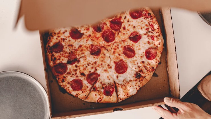 Pizza redonda en caja cuadrada.