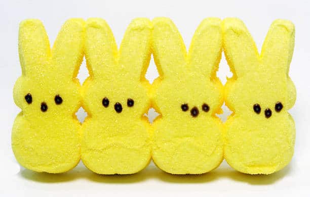 Four yellow candy marshmallow Easter bunnies. Generic brand. Horizontal.
