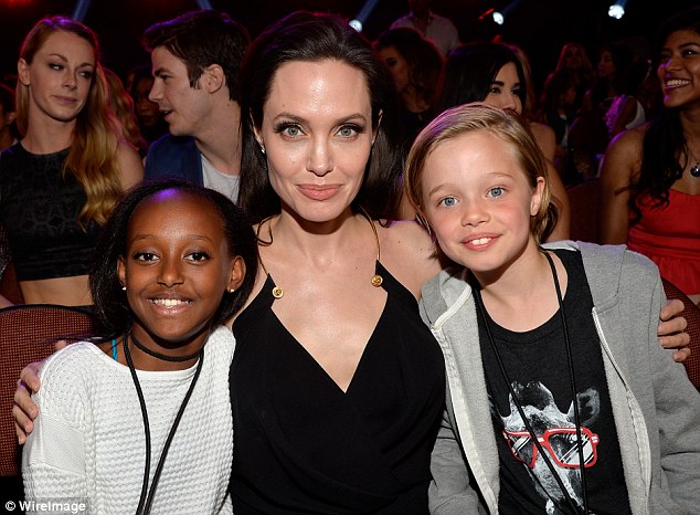 Life of riches: Zahara, pictured left above with Angelina Jolie and sister Shiloh, right in 2015, was born into grinding poverty in Ethiopia but adopted by Jolie after her mother fell ill after the birth. Zahara's birth mother, who gets by on less than £15 a week, wants to be able to talk to her