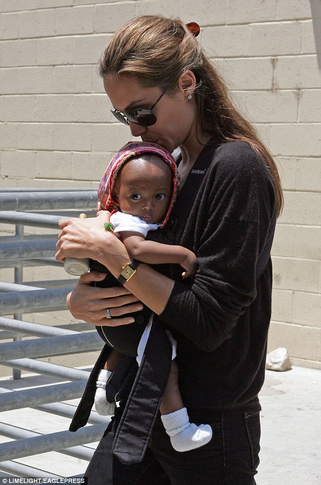 Maternal: Angelina Jolie was clearly besotted with her newly adopted daughter Zahara as she planted a kiss on her head just after her arrival in the United States in 2005