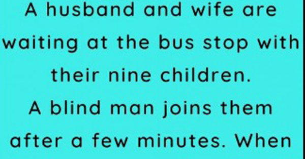 A husband and wife are waiting at the bus stop