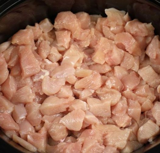 Put diced chicken and brown sugar into a slow cooker for this take-out favorite